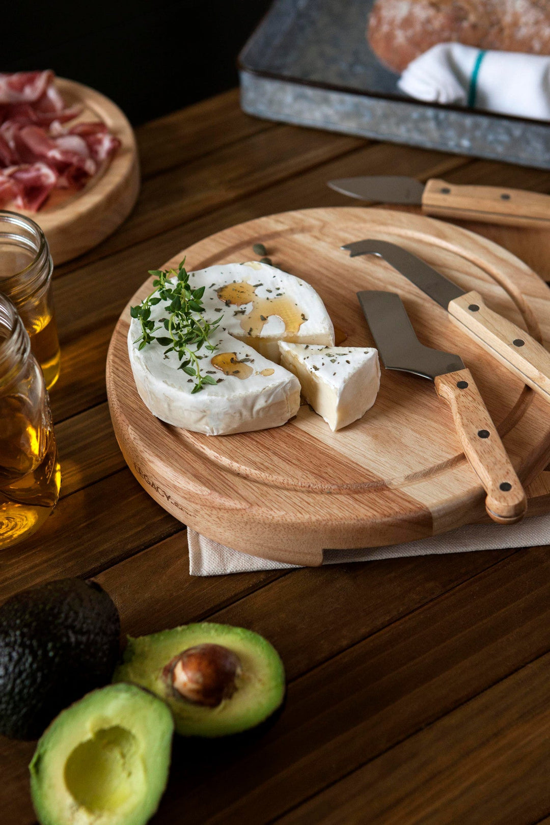 Wooden cutting board with cheese, herbs, and knife from Vegas Golden Knights Circo Cheese Set