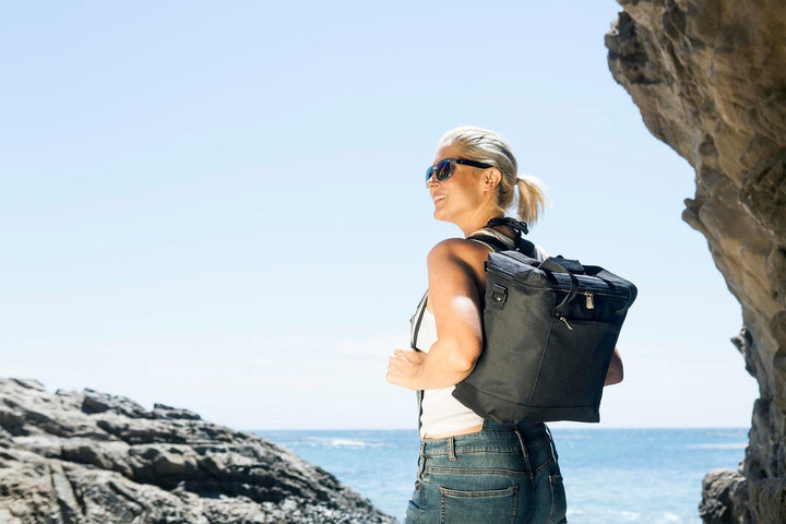 Woman in sunglasses with a Vegas Golden Knights Montero tote bag by rocky cliffs