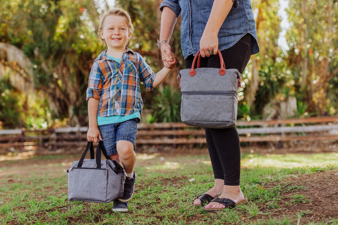 Young child in plaid shirt smiles with Vegas Golden Knights lunch bag cooler