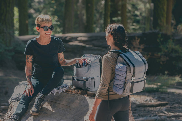 Two people enjoying outdoor conversation with Vegas Golden Knights Traverse Backpack Cooler