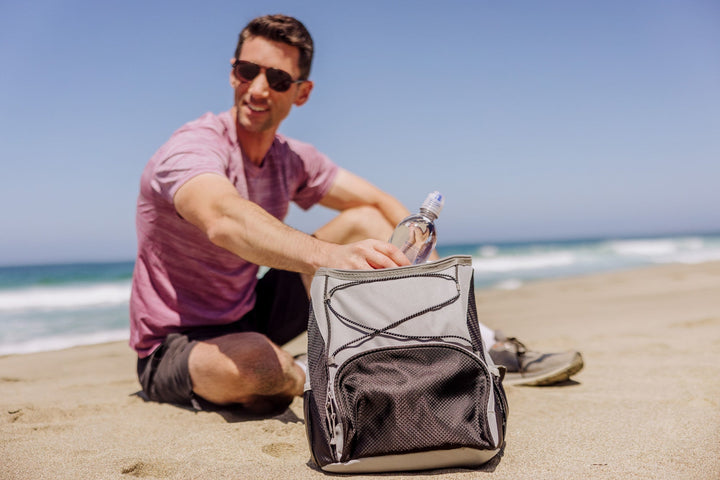 Man on beach with Vegas Golden Knights PTX Backpack Cooler for outdoor adventures