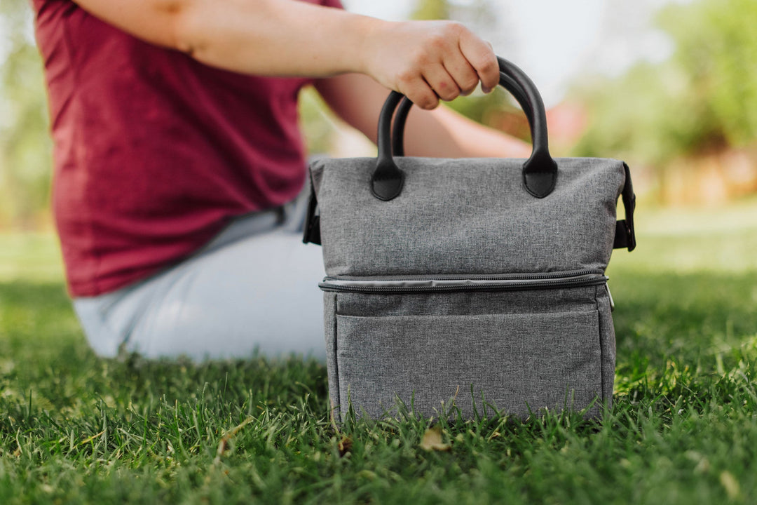 Gray fabric Urban Lunch Bag Cooler on grass perfect for outdoor meals and events